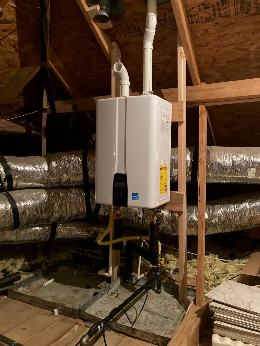 An attic after a tankless conversion, with new venting run through the roof.